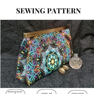May include: A sewing pattern for a clutch bag with a colorful, intricate design. The bag features a gold-colored frame and a black background with a teal, purple, and red pattern. The image includes icons for sewing level, paper size, and instructions.