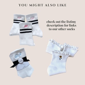 May include: White socks with embroidered initials, black stripes, and a sunflower design. The image includes text that says "You might also like" and "check out the listing description for links to our other socks."