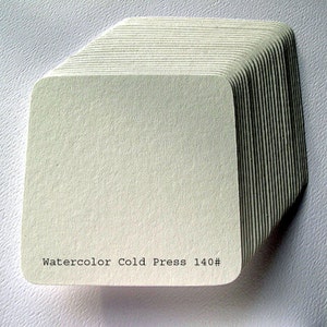 May include: A stack of white watercolor paper sheets, labeled "Watercolor Cold Press 140#"