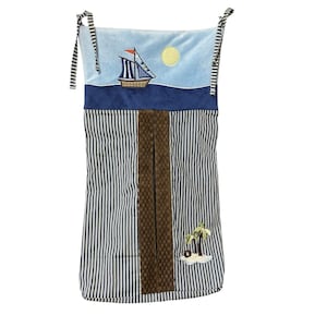 May include: A nautical-themed nursery organizer with a blue and white striped pattern. The top features a blue sky with a sailboat and a yellow sun. A brown woven pocket is centered on the front, and a small island with palm trees is at the bottom.