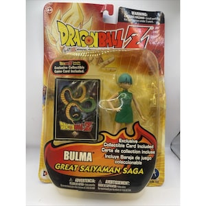 May include: A Dragon Ball Z Bulma action figure from the Great Saiyaman Saga, packaged in a blister card with an exclusive collectible game card featuring a green dragon illustration. The figure has teal hair and wears a sleeveless green dress.