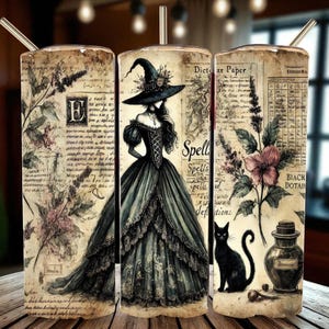 May include: Three stainless steel tumblers with straws showcase a vintage witch theme. The design includes a witch in a gown, botanical illustrations, script, and a black cat. The tumblers have a distressed, antique paper background.