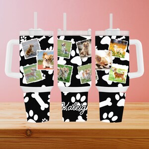 May include: Three white travel mugs with black and white paw print designs and a collage of photos of small dogs. The middle mug has the name "Kaleigh" written on it.