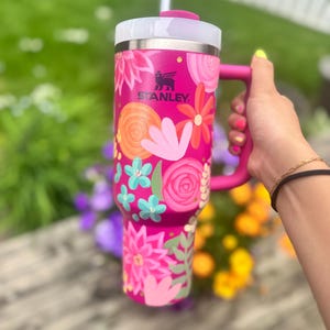 May include: A set of three ceramic mugs with a speckled, matte finish in cream, light grey, and dark grey. Each mug has a simple, minimalist design, suitable for coffee or tea.