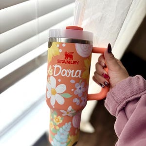 May include: A handcrafted wooden sign, painted white with a distressed effect, displaying the words "Welcome to our home" in a handwritten font. The sign has a dark brown border and is suitable for indoor or outdoor use.