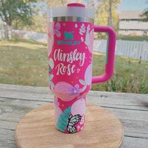 May include: A rustic wooden sign with the text "Welcome to our home" in white lettering. The sign has a distressed finish and a simple, inviting design, ideal for entryway decor.