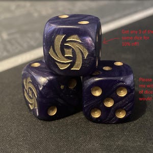 May include: Three dark blue dice with gold-colored pips and a gold emblem on one face. The dice are stacked, with the text "Get any 3 of the same dice for 10% off!" and "Please message me with the type of dice you would like" in the background.