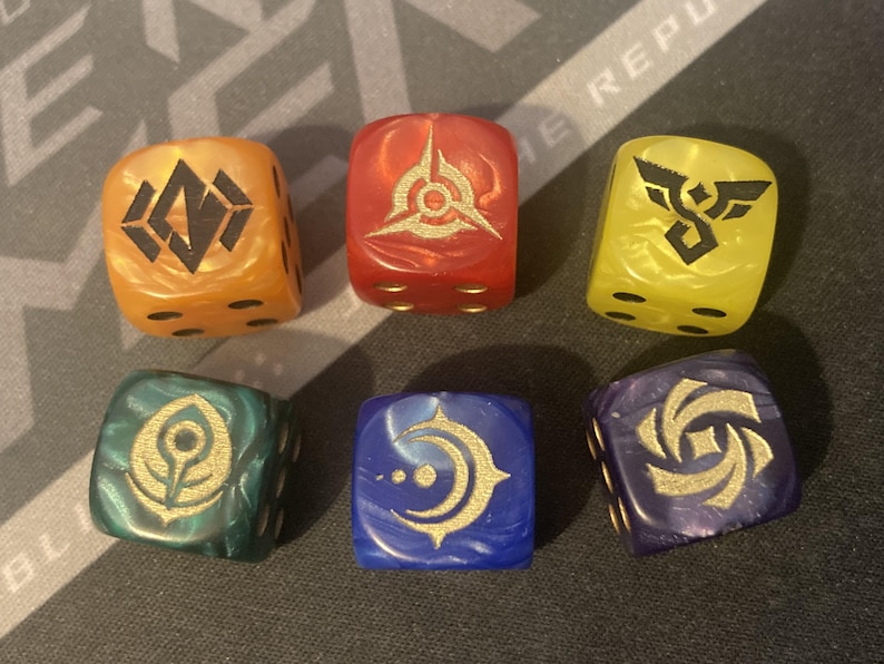May include: Six colorful, marbled dice with gold symbols. The dice are orange, red, yellow, green, blue, and purple. Each die has a different symbol and number of dots. Ideal for tabletop gaming.