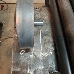 May include: A metal roller with a diameter of 2 inches, 3.5 inches, and 5 inches. The roller is marked with the measurements in inches.