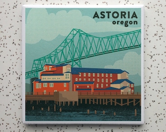 May include: A retro-style illustration of a red brick building with a green bridge in the background. The text "ASTORIA oregon" is at the top of the image.