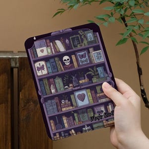 May include: A purple rectangular tablet featuring a detailed illustration of a bookshelf filled with books, a skull, and framed pictures. The text "Mey's Kindl" is visible on the bottom right. The overall theme is gothic and literary.