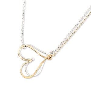 May include: A silver and gold necklace with a double chain and a heart pendant. The heart is made of two intertwined pieces of metal, one silver and one gold.