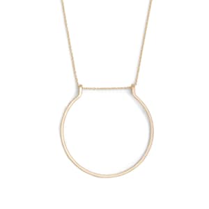 May include: A gold necklace featuring a simple circle pendant. The pendant is open at the top and bottom, creating a unique and modern design.