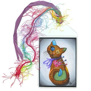 May include: A whimsical artwork featuring a brown cat doll with patches, pins, and a purple ribbon. The cat is inside a clear sleeve with a purple ribbon and colorful threads. The cat has a blue button eye and a cross patch.