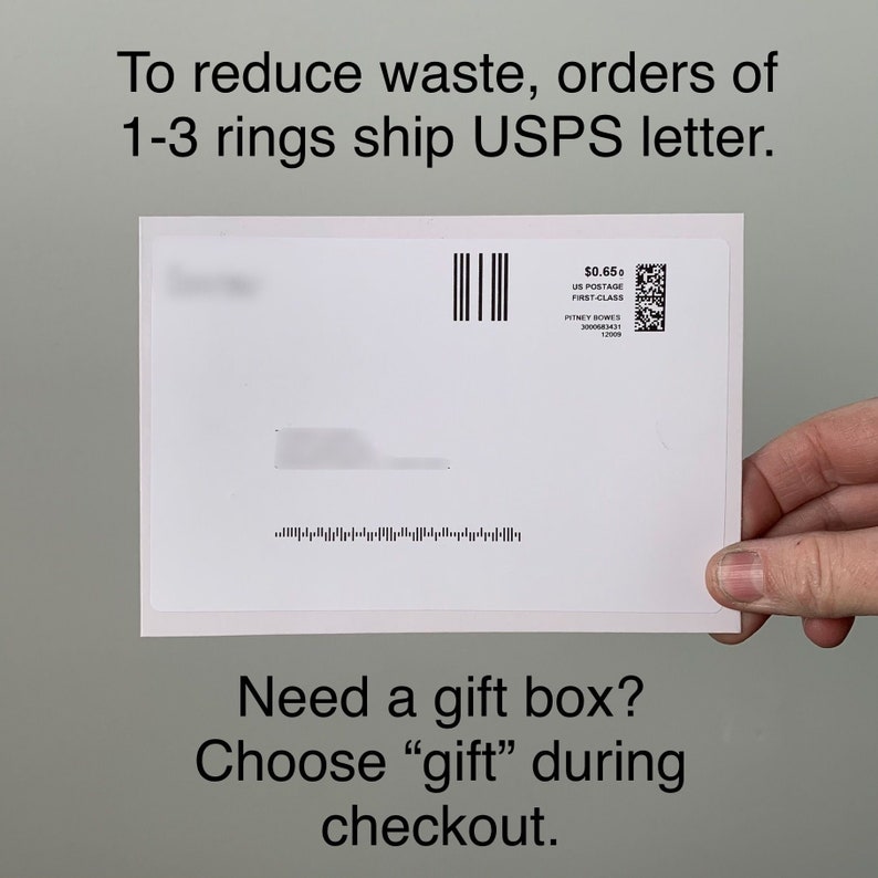 May include: White envelope with a postage stamp for $0.65. The stamp says "US Postage First-Class" and has a barcode. The text "To reduce waste, orders of 1-3 rings ship USPS letter." is at the top of the envelope. The text "Need a gift box? Choose "gift" during checkout." is at the bottom of the envelope.