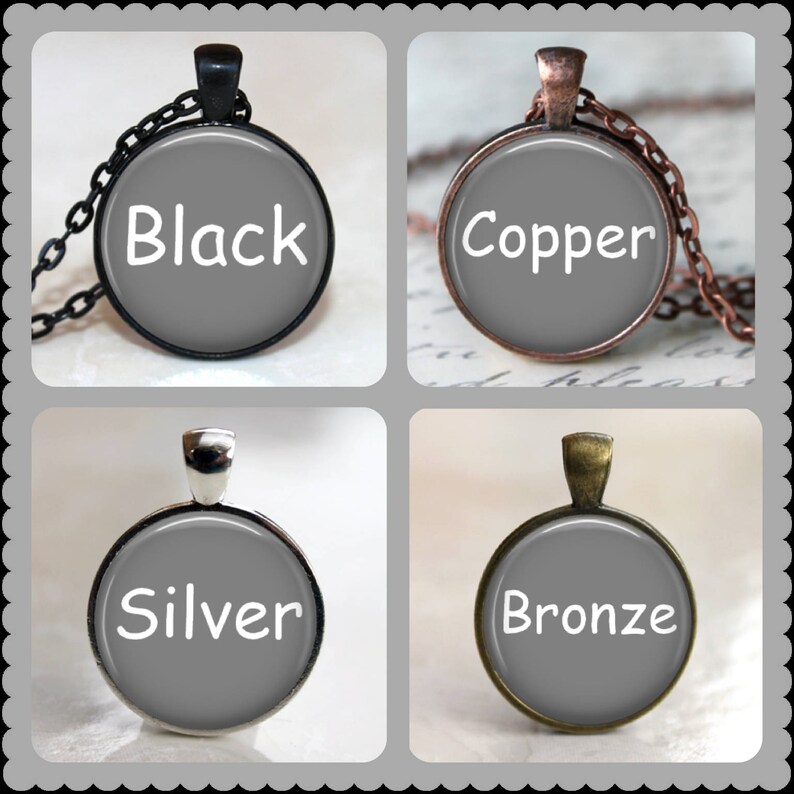 May include: Four necklaces with round glass pendants. The pendants are gray and have the words "Black", "Copper", "Silver", and "Bronze" written in white.