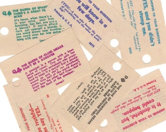 May include: A collection of vintage game cards with various questions and answers. The cards are printed on brown paper with black and pink text. The cards feature a variety of topics, including gossip, money, and hard work.