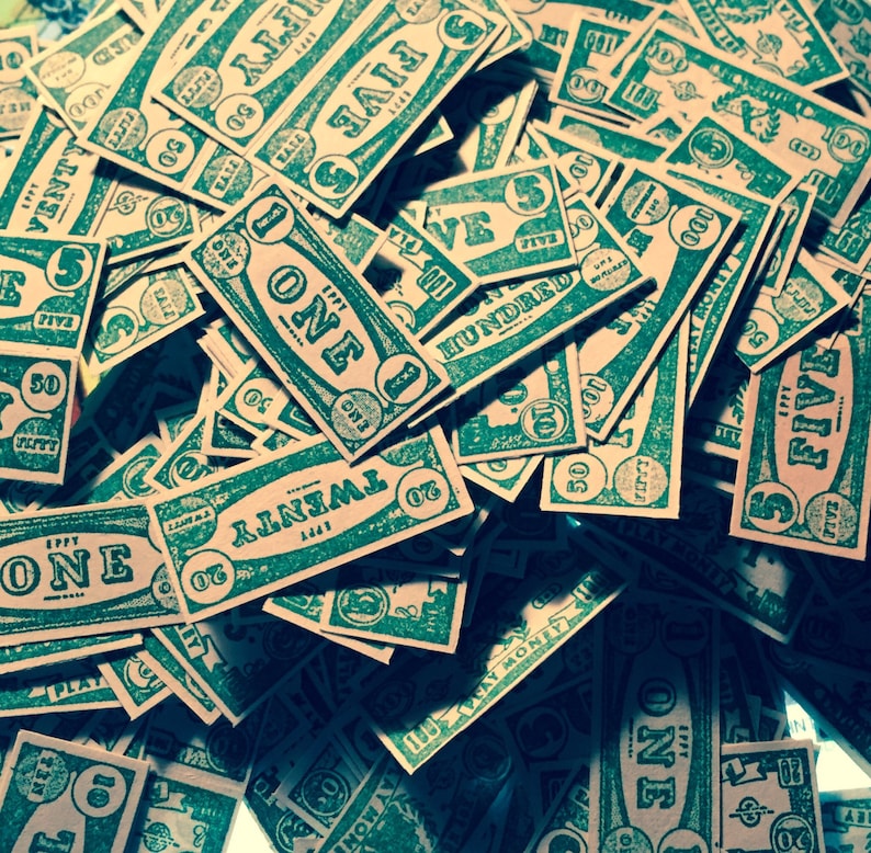May include: A pile of green and white paper game cards with various denominations, including "One", "Five", "Twenty", "Fifty", and "One Hundred".