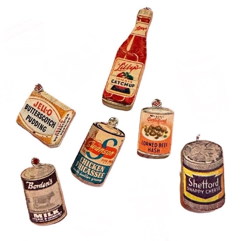 May include: A collection of vintage-style food product ornaments, including a ketchup bottle, Jell-O pudding, canned chicken fricassee, corned beef hash, milk, and snappy cheese. Each ornament is detailed with brand names and product labels.