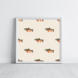 May include: A white framed print featuring a repeating pattern of brown and orange trout on a cream background.