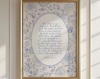 May include: A framed print with a gold-colored frame. The artwork features a floral pattern in light blue and white. Inside an oval, handwritten text reads "The Lord is my shepherd..." from Psalm 23:1-4.
