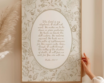 May include: Framed wall art featuring a floral pattern in beige and white. The artwork includes an oval-shaped text box with a religious quote from Psalm 23:1-4 in a serif font. The frame is a light brown color.
