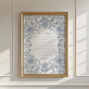 Può includere: Stampa incorniciata con il Padre Nostro, circondata da un bordo floreale blu. Il testo è centrato su uno sfondo color crema e la cornice è dorata. La stampa è esposta su una parete bianca.