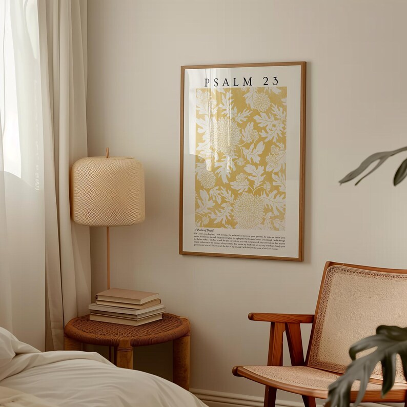 May include: A framed print with a yellow background and white floral design. The print has the text "PSALM 23" at the top and a passage of text below the floral design.