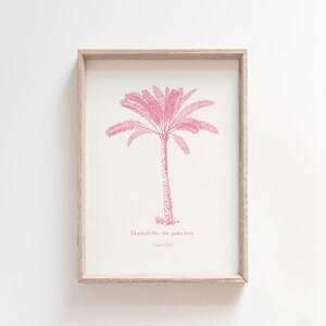 Puede incluir: Una impresi&oacute;n enmarcada con una ilustraci&oacute;n de palmera rosa y el texto "Flourish like the palm tree Psalm 92:12".