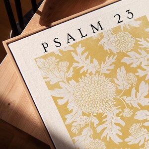 May include: A yellow and white floral print with the text "PSALM 23" in black lettering.