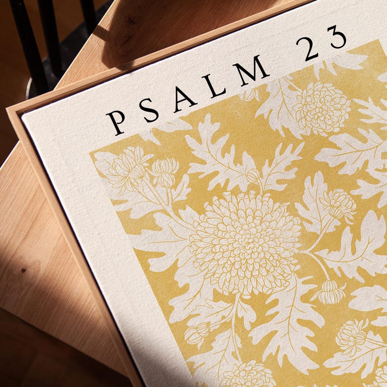 May include: A yellow and white floral print with the text "PSALM 23" in black lettering.
