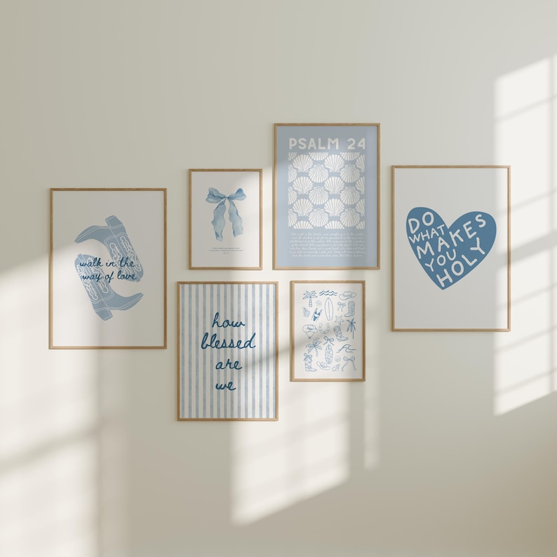 May include: A set of framed art prints with a light blue and white colour scheme. The prints display various designs, including cowboy boots, a bow, seashells, and inspirational quotes such as "Do What Makes You Holy."