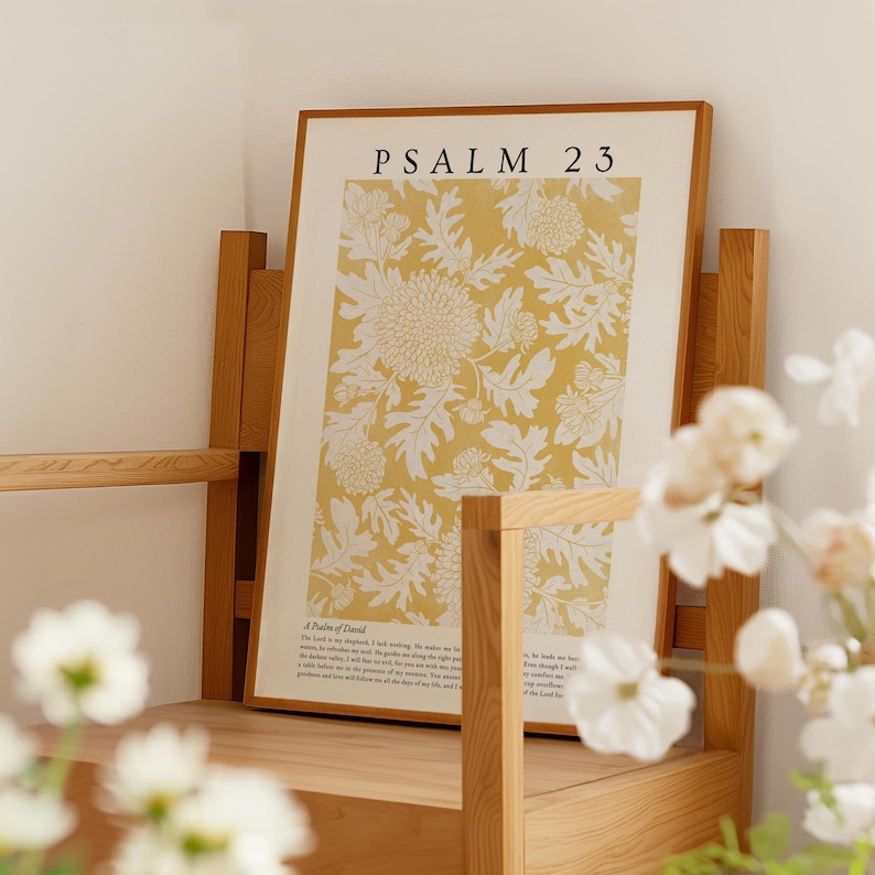 May include: A framed print with a yellow background and white floral design. The print includes the text "PSALM 23" and a portion of the 23rd Psalm.