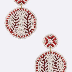 May include: A pair of white and red beaded earrings with a leaf design. The earrings are round and have a small, red beaded top.