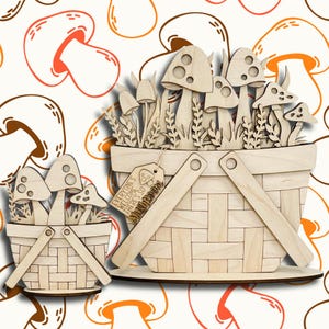 May include: Wooden mushroom basket decor with a variety of mushroom shapes and greenery. The basket has a handle and a tag that reads "Everyone's Welcome There's So Mushroom". The background features a repeating mushroom pattern.