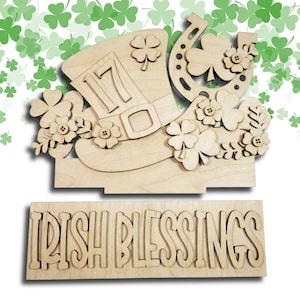 May include: Wooden St. Patrick's Day decoration featuring a leprechaun hat with the number 17, a horseshoe, and shamrocks. The words "IRISH BLESSINGS" are displayed on a separate wooden plank below the main decoration. The design is made of unfinished wood.