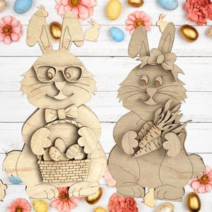 May include: Two wooden Easter bunny cutouts. One bunny wears glasses and a bow tie, holding a basket with Easter eggs. The other bunny has a bow and holds carrots. The background includes Easter eggs and flowers.