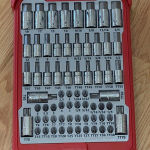 May include: A red tool case with a clear lid, filled with various chrome sockets and bits. The case is organized with sizes labeled in inches, including 3/4, 1/2, 9/16, and 5/8. The set includes T60 and T70 bits.