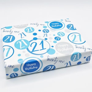 May include: White gift wrap with a blue and grey pattern of circles. The circles have the number 21 inside and the words "Happy Birthday" and "Twenty One" are scattered throughout the pattern.