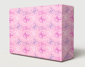 May include: A pink gift box wrapped in paper with a repeating pattern of the number "30" in white, purple, and pink. The words "Happy Birthday!" are also scattered across the wrapping.