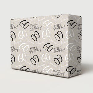 May include: A rectangular gift box wrapped in beige paper featuring a repeating pattern of the number 60 in black and white, along with the text Happy Birthday and Celebrate in script font, accented by small white dots across the entire surface.