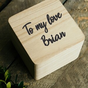 May include: A wooden box with the text "To my love Brian" written on it.
