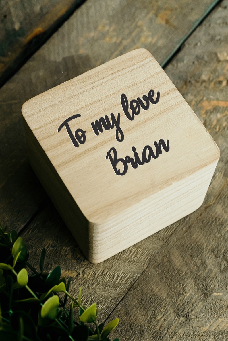 May include: A wooden box with the text "To my love Brian" written on it.