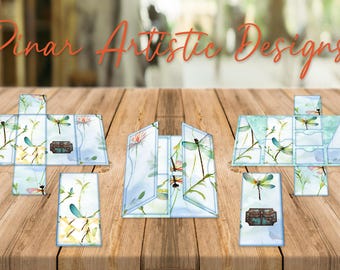 May include: A set of six blue and white paper crafting cards featuring a dragonfly design. The cards are folded and ready to be assembled into a box.