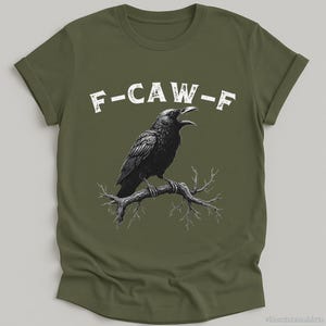 May include: A green t-shirt with a black crow illustration and the text "F-CAW-F" printed in white.