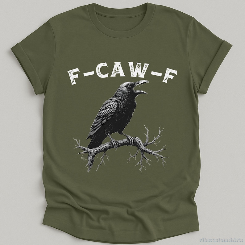 May include: A green t-shirt with a black crow illustration and the text "F-CAW-F" printed in white.