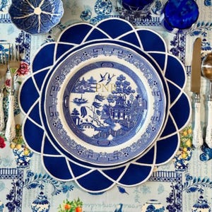 Gather navy blue embroidered fabric placemat with white scalloped edge styled under vintage chinoiserie plate for elegant table setting