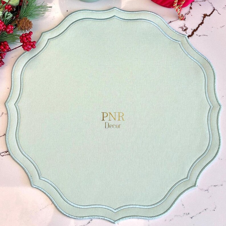 Top view of square scalloped placemat in soft green creating a fresh seasonal table look
