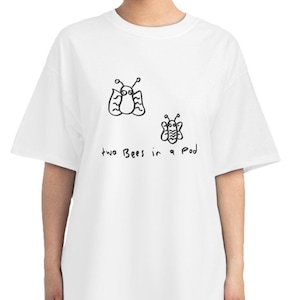 May include: White t-shirt with a black and white illustration of two bees and the text "two Bees in a Pod".