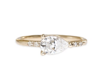 moissanite engagement ring, sideways pear, made with SCS recycled 14k and 18k gold